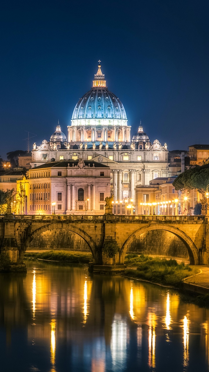 White Concrete Building Near Body of Water During Night Time. Wallpaper in 720x1280 Resolution