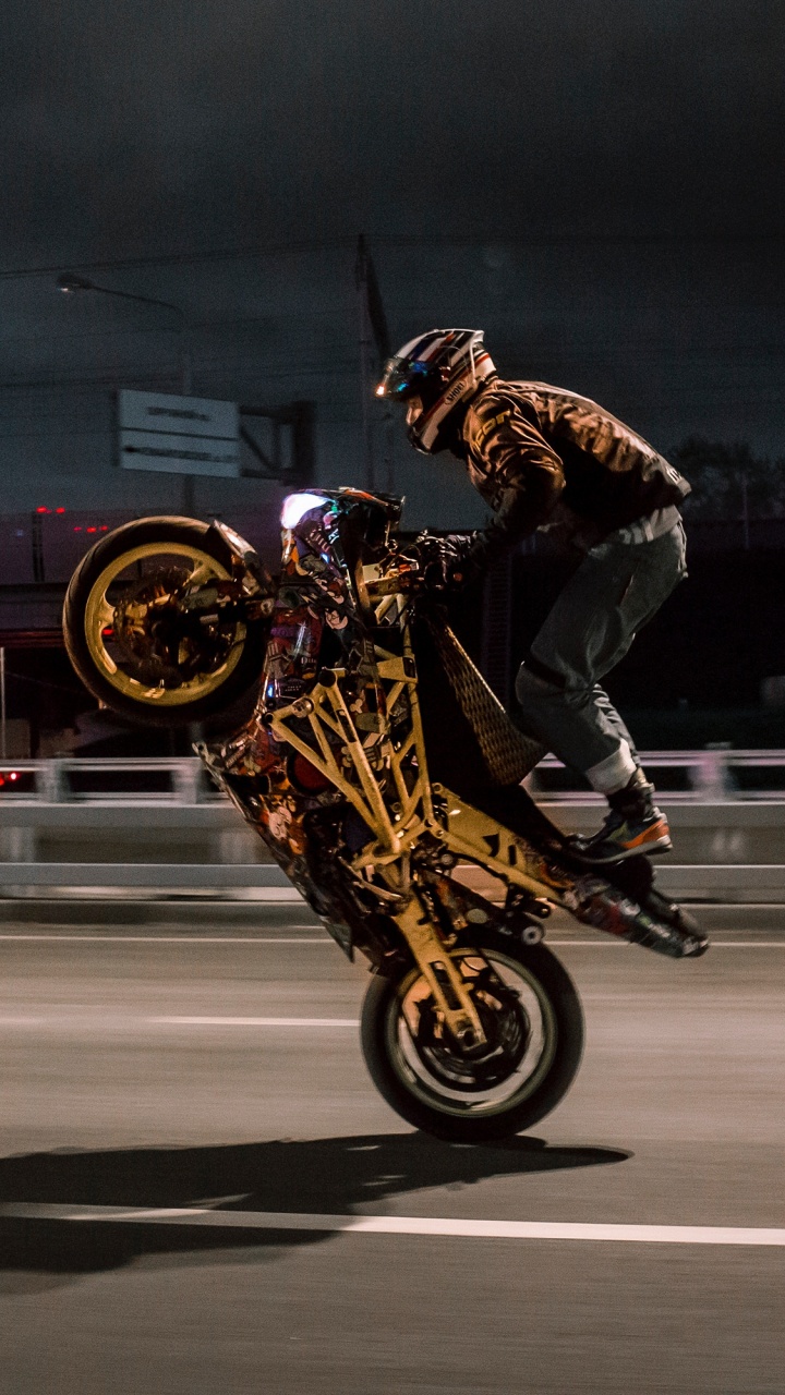 Man in Black Jacket Riding on Yellow Motorcycle. Wallpaper in 720x1280 Resolution