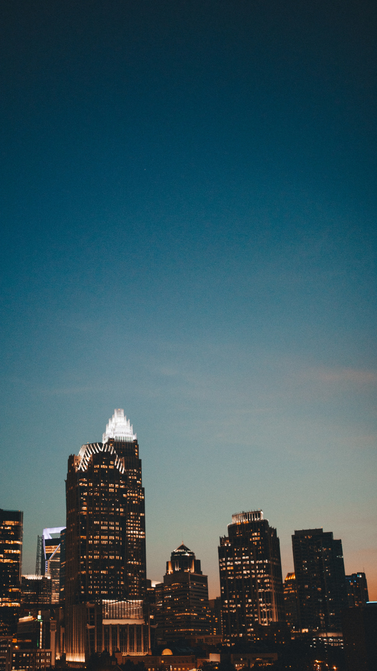 City Skyline Under Blue Sky During Night Time. Wallpaper in 750x1334 Resolution