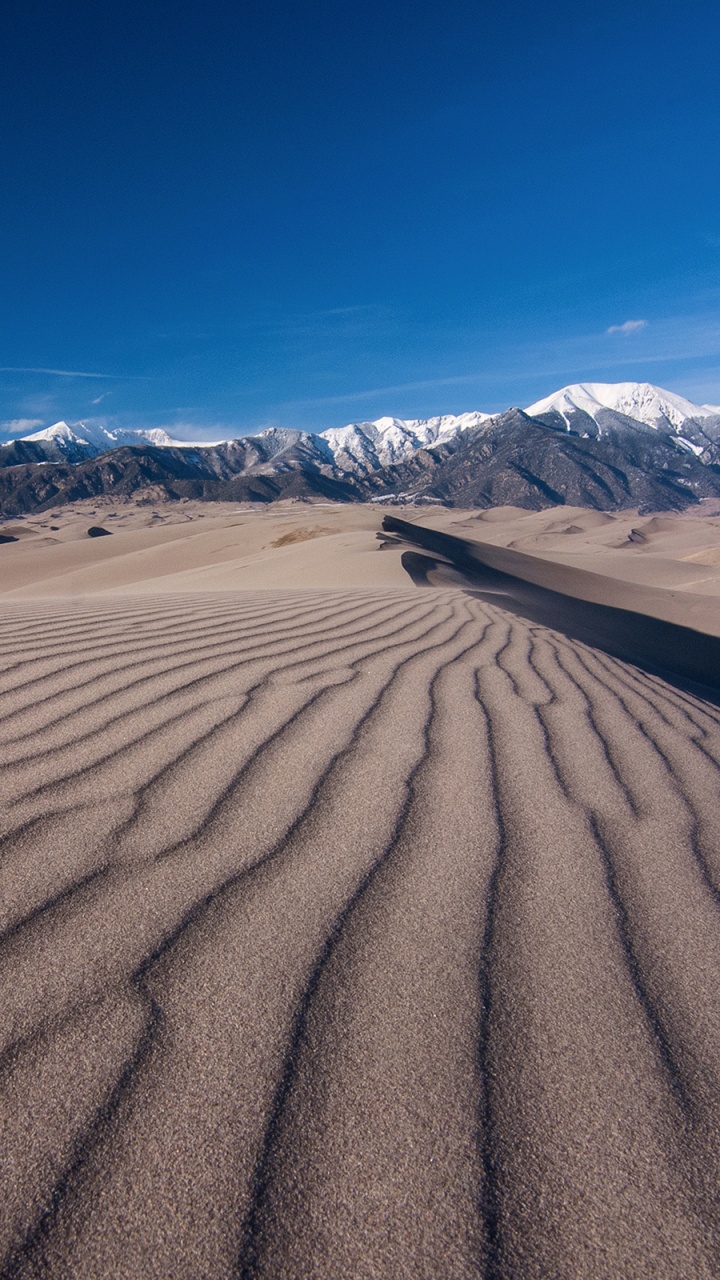 Brown Sand Under Blue Sky During Daytime. Wallpaper in 720x1280 Resolution