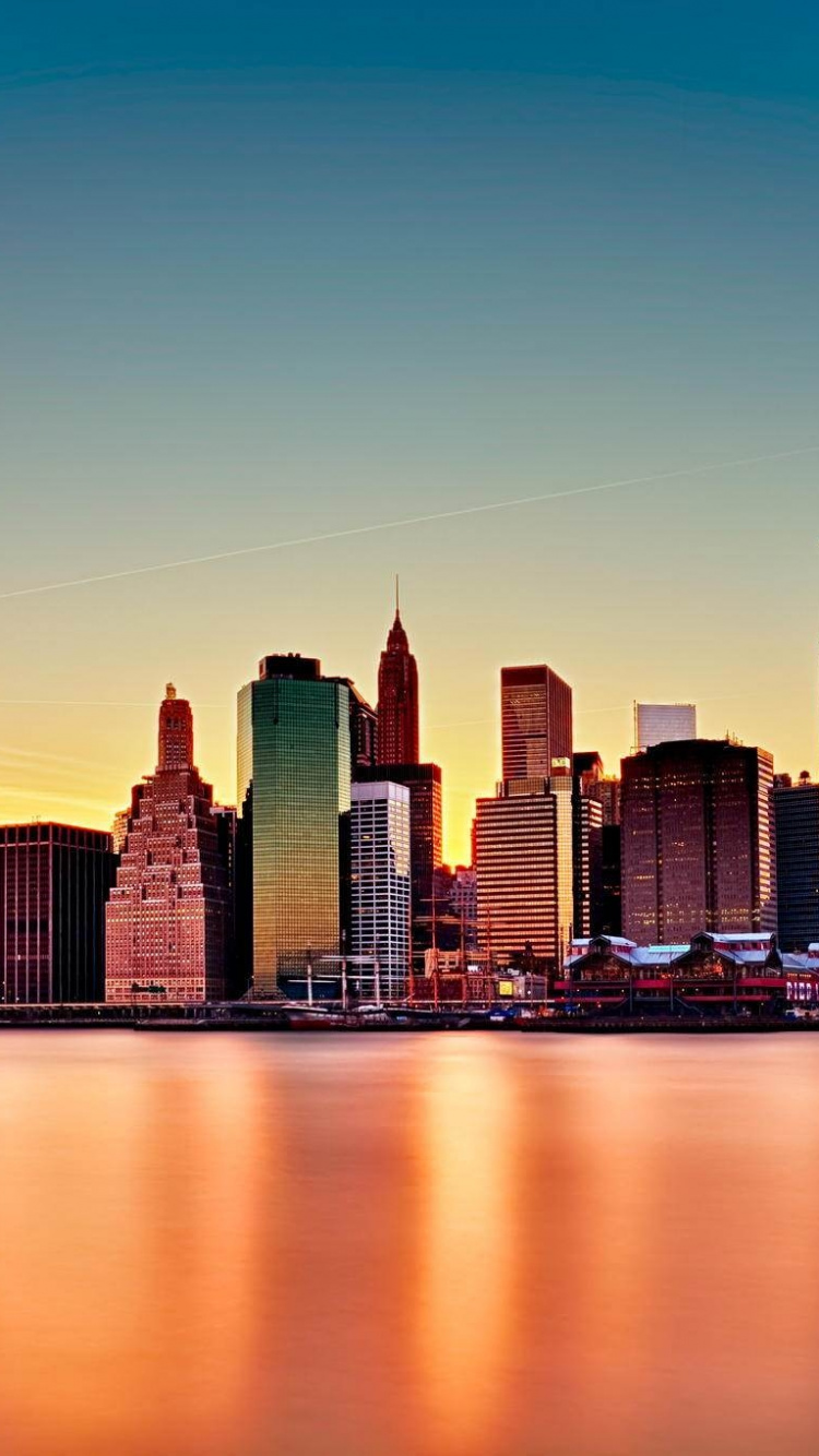 City Skyline Across Body of Water During Night Time. Wallpaper in 750x1334 Resolution