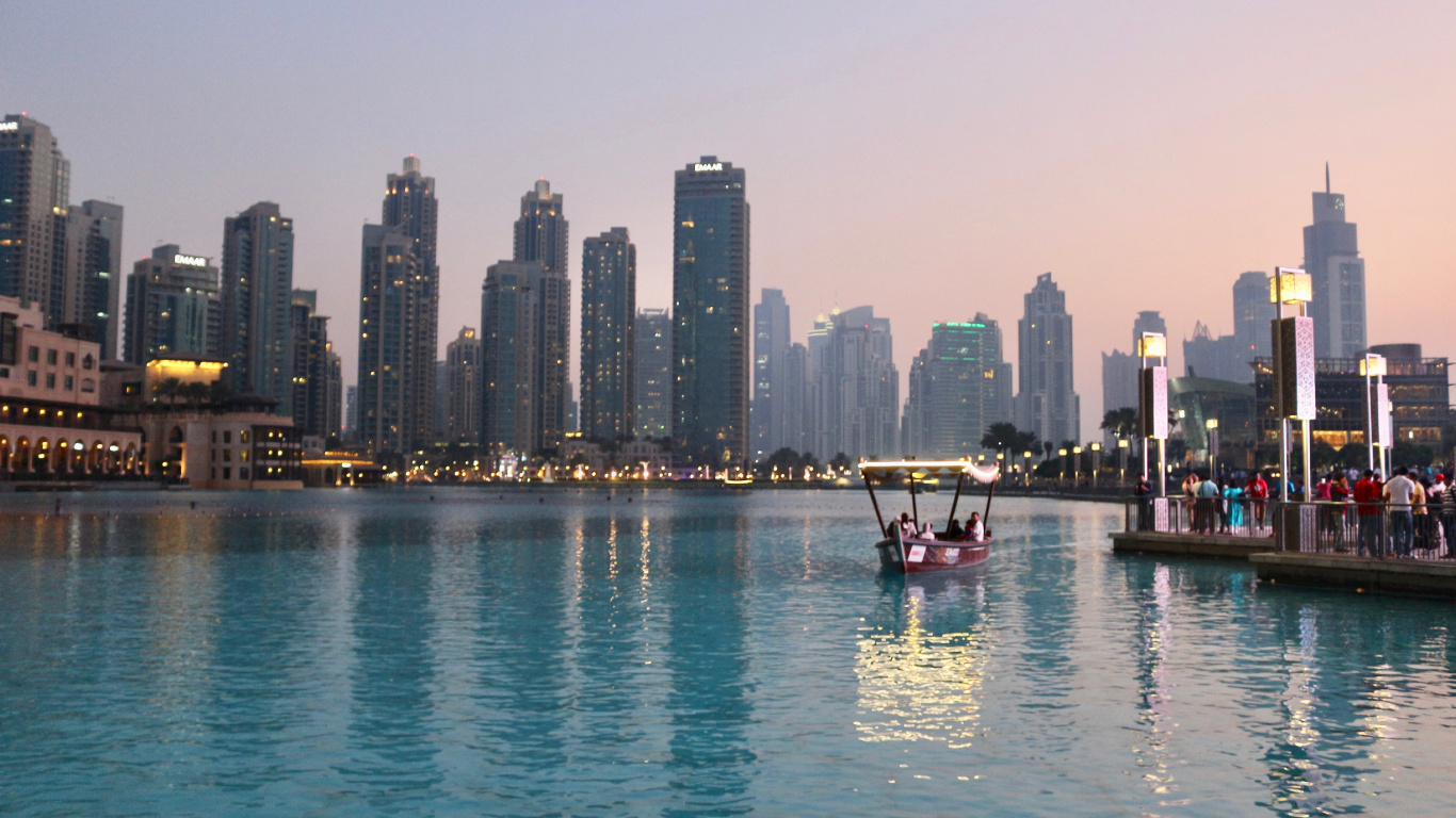 Red Boat on Body of Water Near City Buildings During Daytime. Wallpaper in 1366x768 Resolution