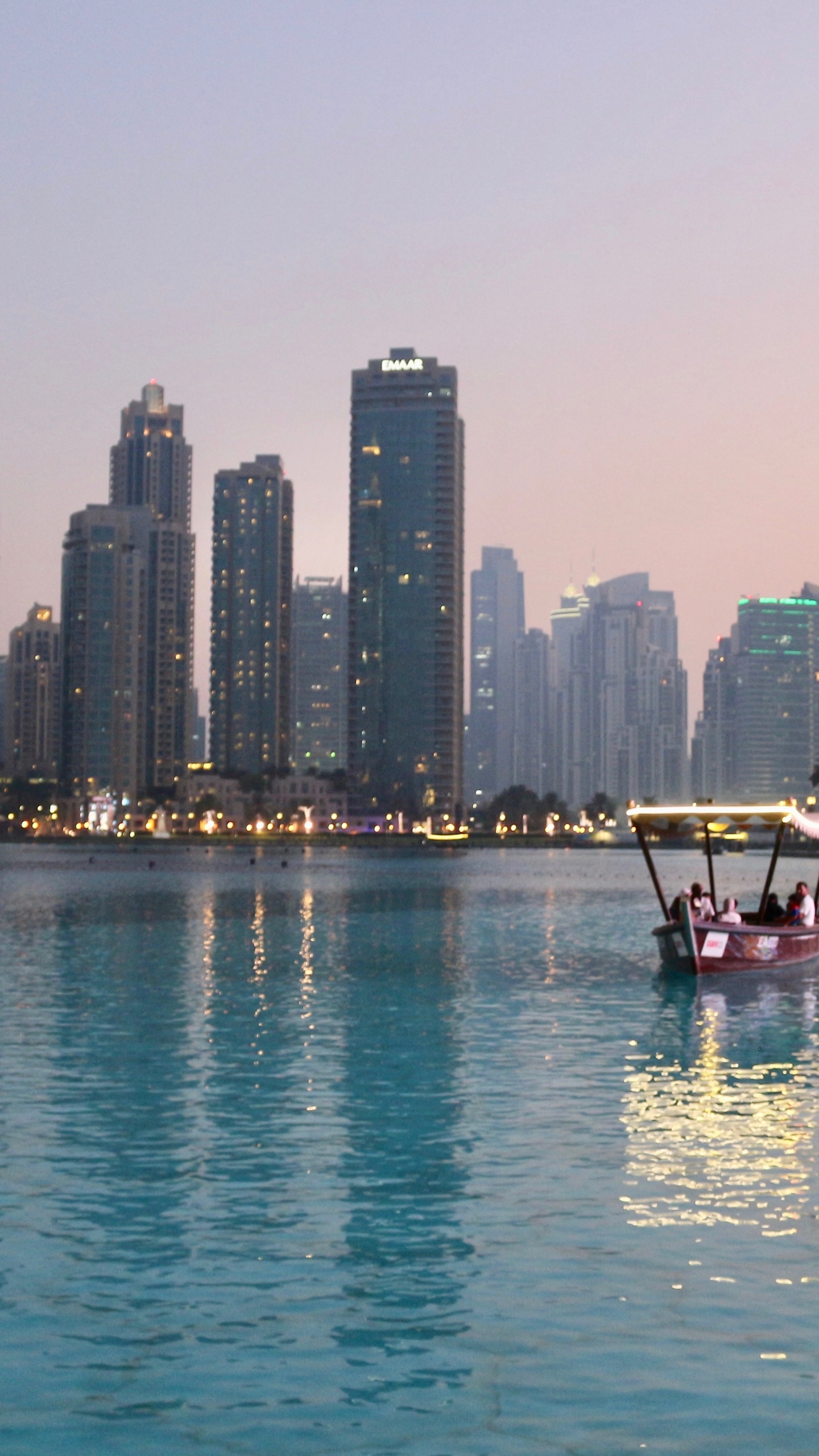 Red Boat on Body of Water Near City Buildings During Daytime. Wallpaper in 1440x2560 Resolution