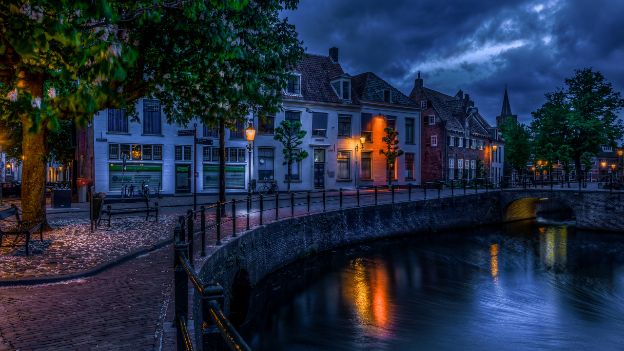 Body of Water Near Green Trees and White Concrete Building During Night Time. Wallpaper in 1280x720 Resolution