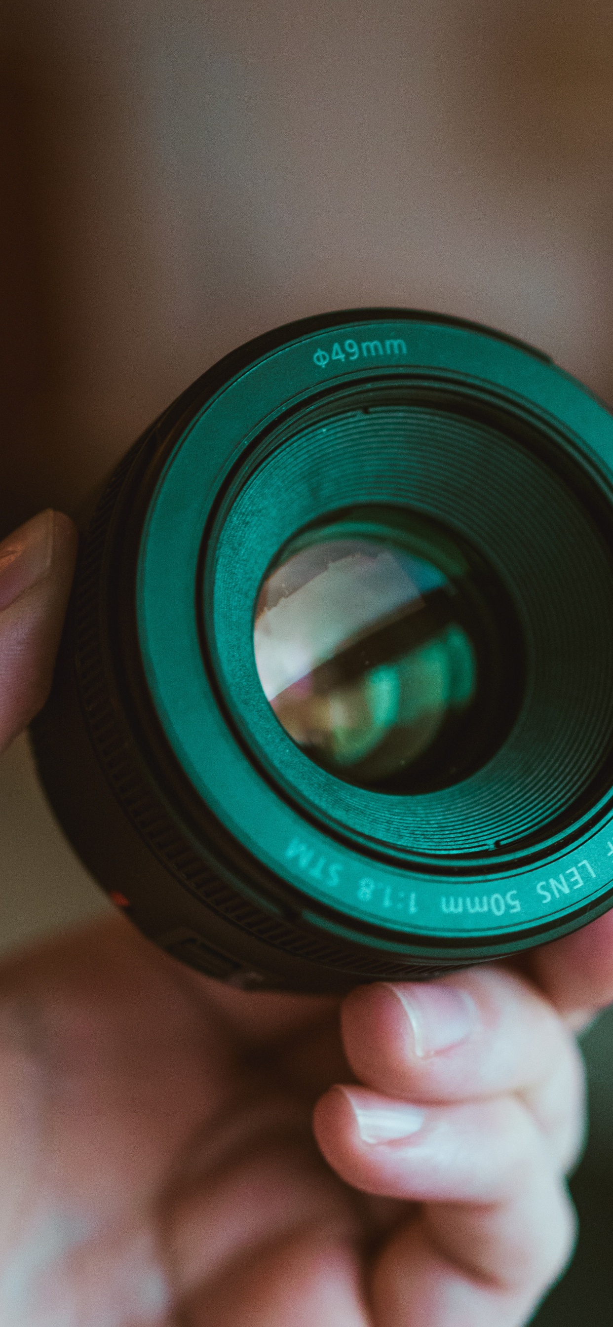 Person Holding Black Camera Lens. Wallpaper in 1242x2688 Resolution
