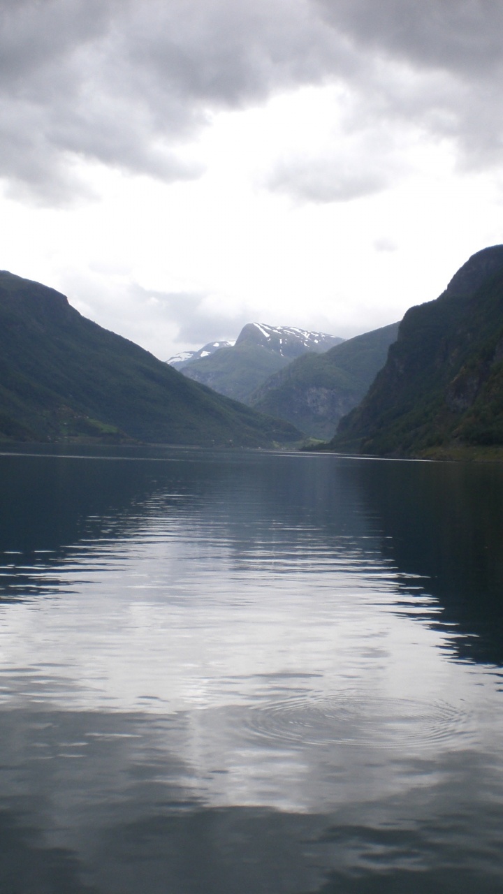 Body of Water Near Mountain Under Cloudy Sky During Daytime. Wallpaper in 720x1280 Resolution