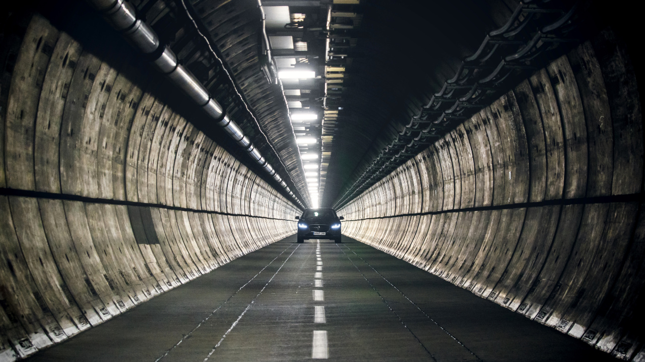 Man in Black Jacket Walking on Tunnel. Wallpaper in 1280x720 Resolution