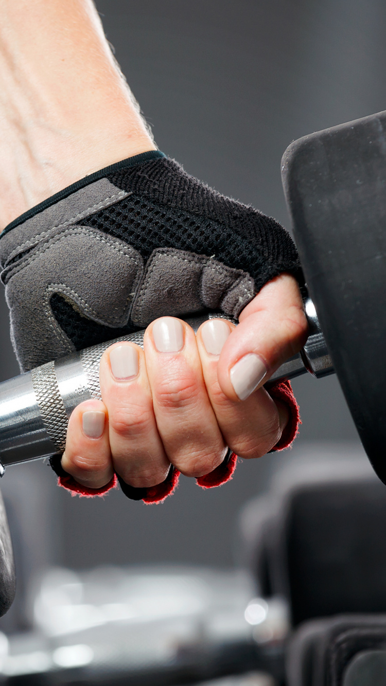 Person Holding Black and Silver Dumbbell. Wallpaper in 750x1334 Resolution