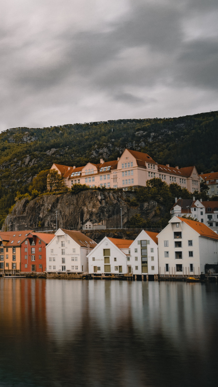 White and Brown Concrete House Near Body of Water During Daytime. Wallpaper in 750x1334 Resolution