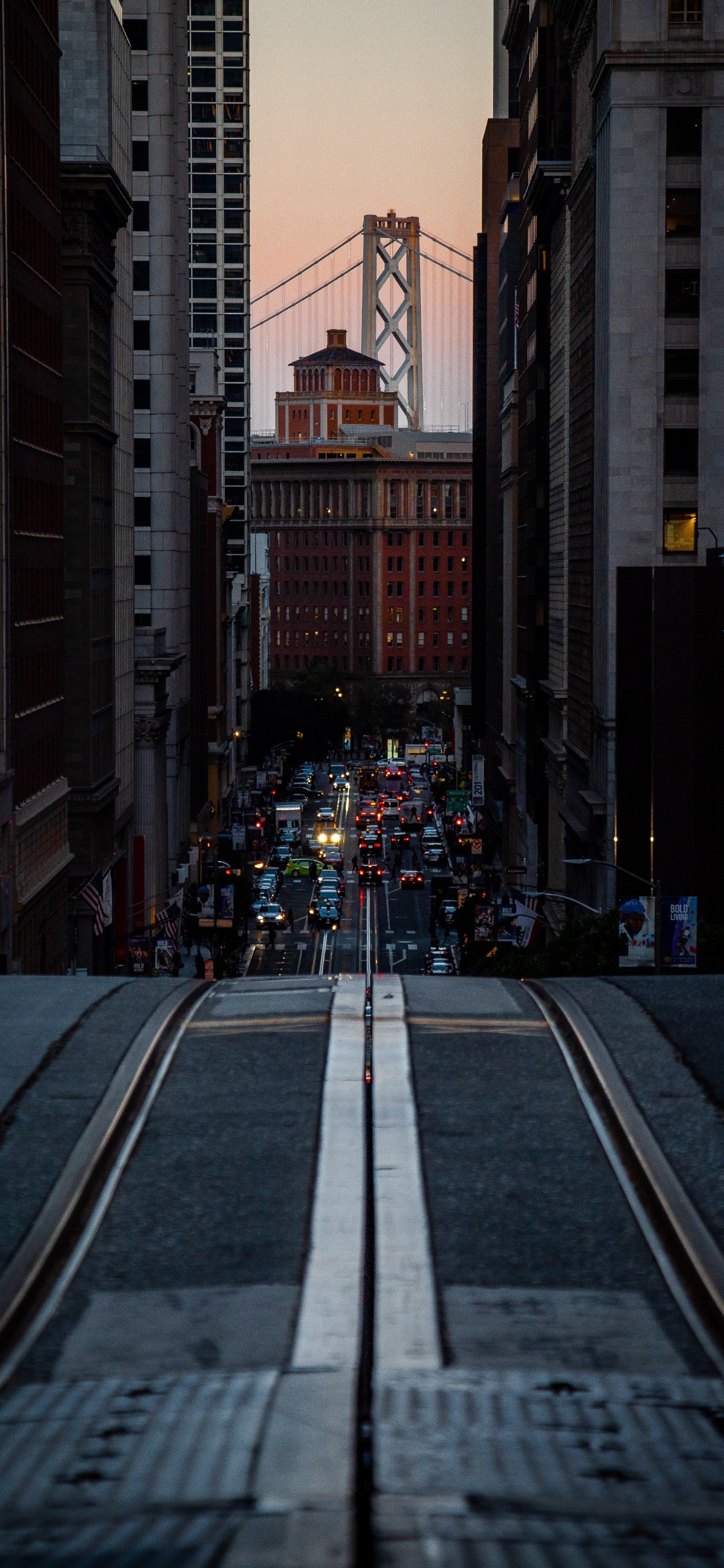 Cars on Road Between High Rise Buildings During Night Time. Wallpaper in 1125x2436 Resolution