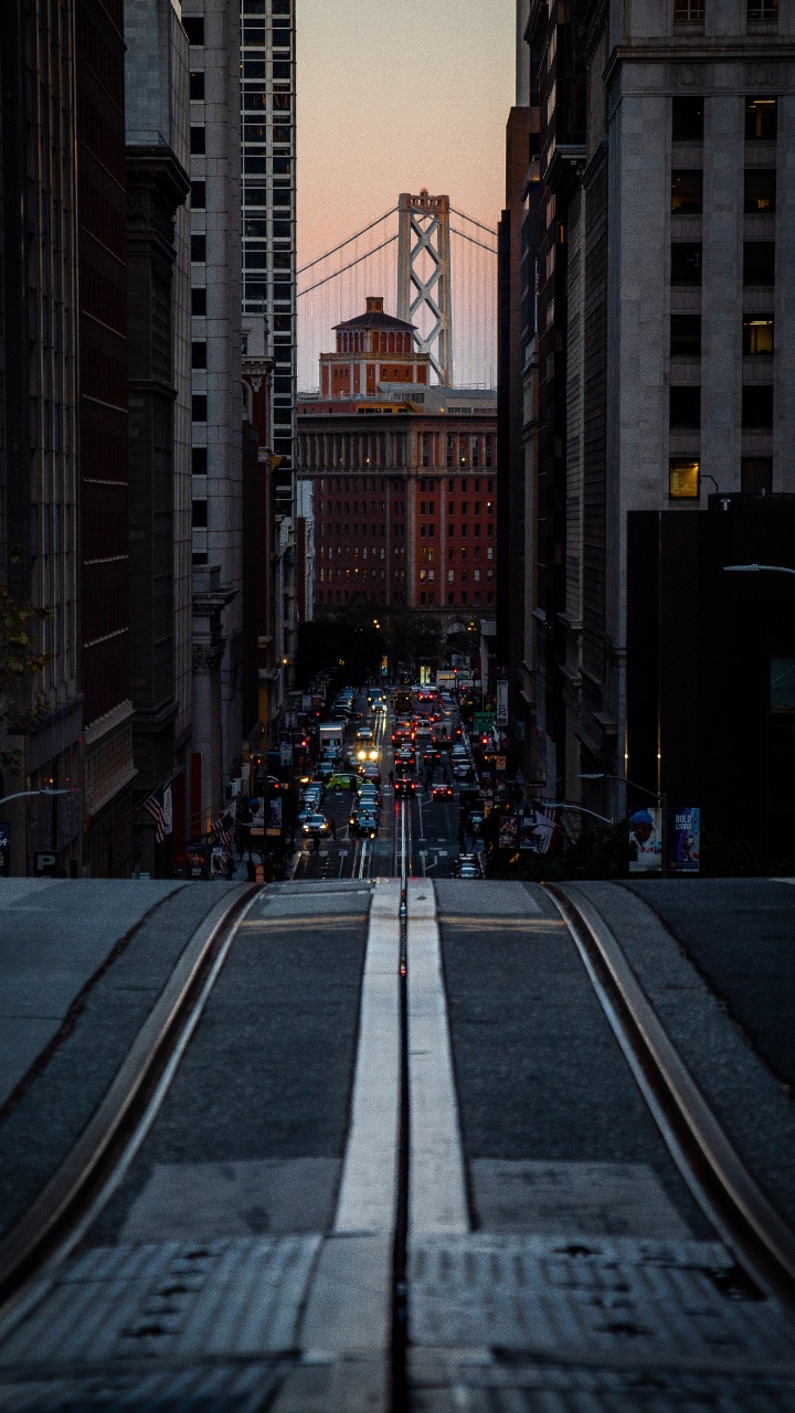 Cars on Road Between High Rise Buildings During Night Time. Wallpaper in 720x1280 Resolution