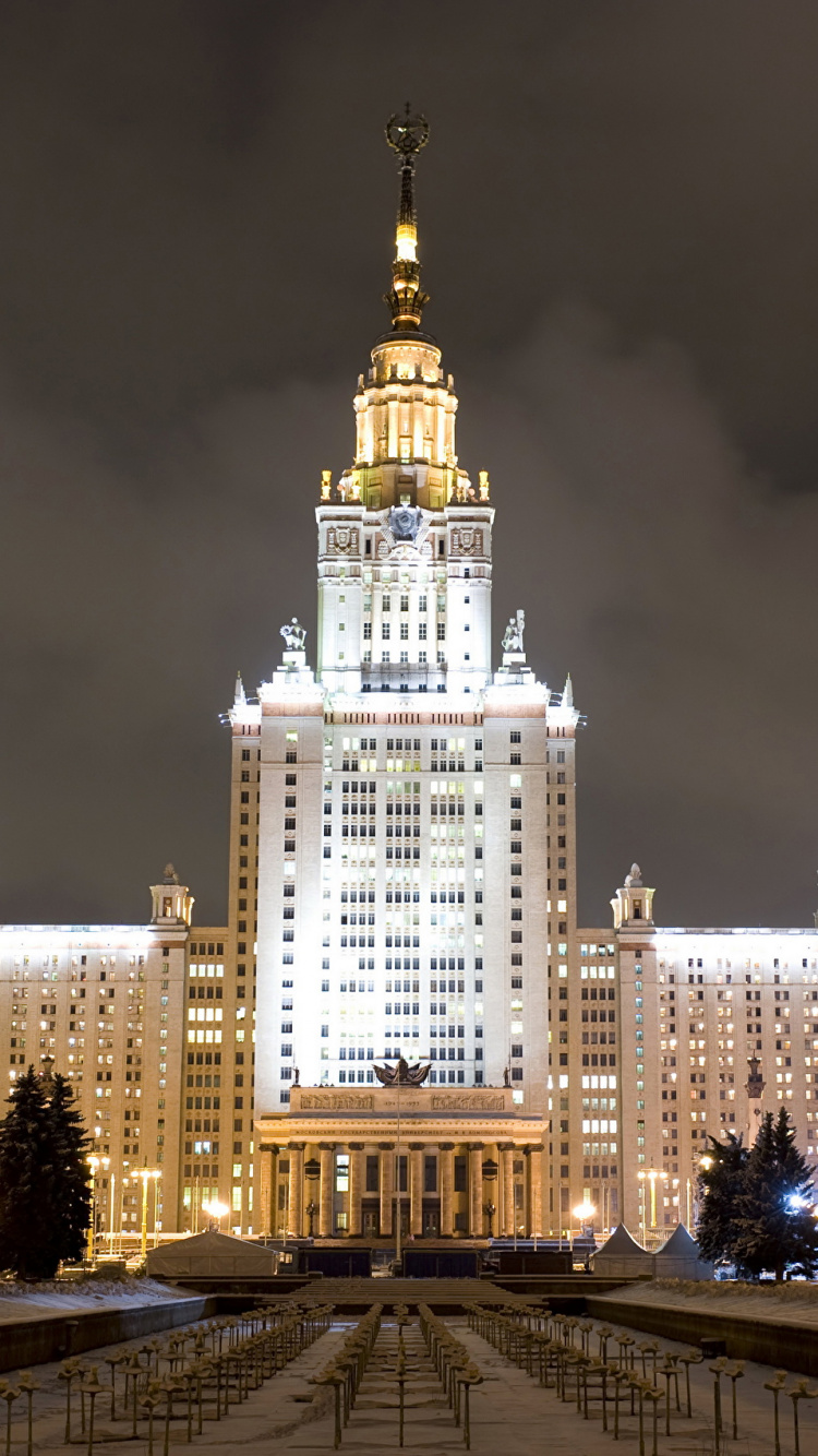 White and Brown Concrete Building During Night Time. Wallpaper in 750x1334 Resolution
