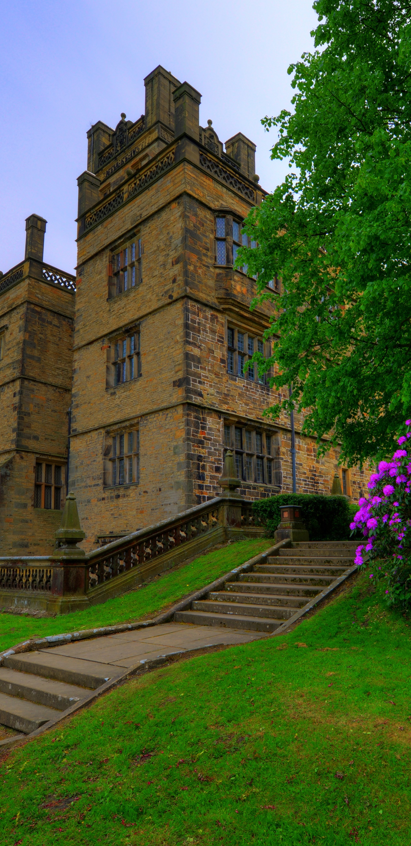 Brown Concrete Building Near Green Trees During Daytime. Wallpaper in 1440x2960 Resolution