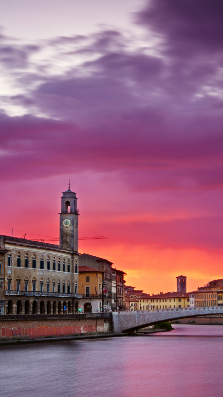 Brown Concrete Building Near River During Night Time. Wallpaper in 750x1334 Resolution