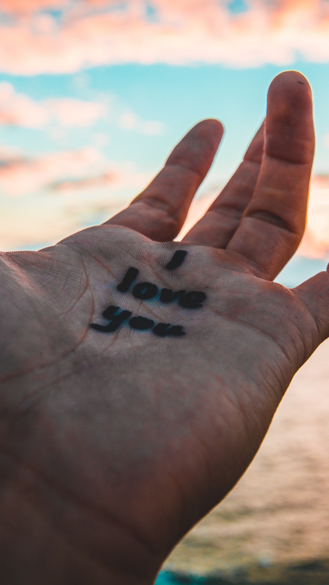 Black Heart Shaped on Persons Hand. Wallpaper in 1080x1920 Resolution