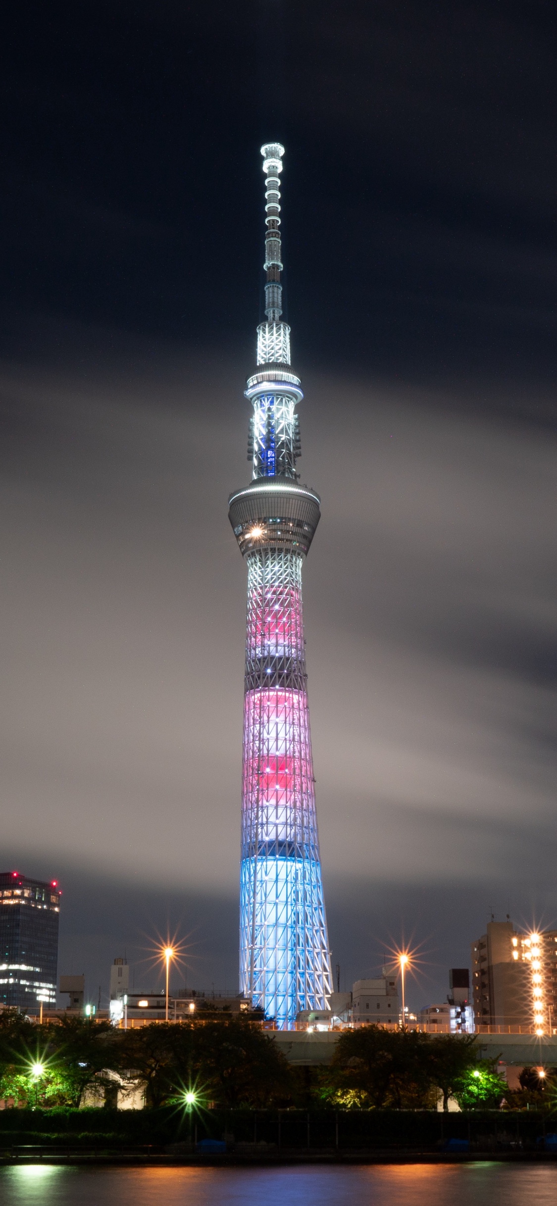 Lighted High Rise Building During Night Time. Wallpaper in 1125x2436 Resolution