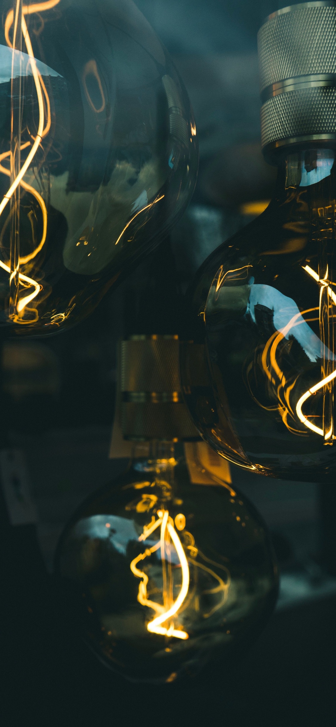 Clear Glass Light Bulb Turned on in Dim Light. Wallpaper in 1125x2436 Resolution