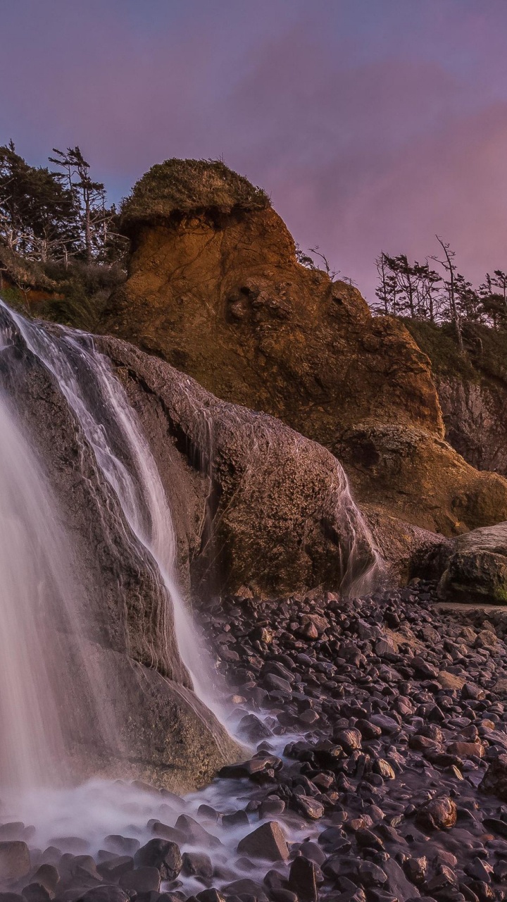 Water Falls on Brown Rocky Mountain Under Gray Cloudy Sky. Wallpaper in 720x1280 Resolution