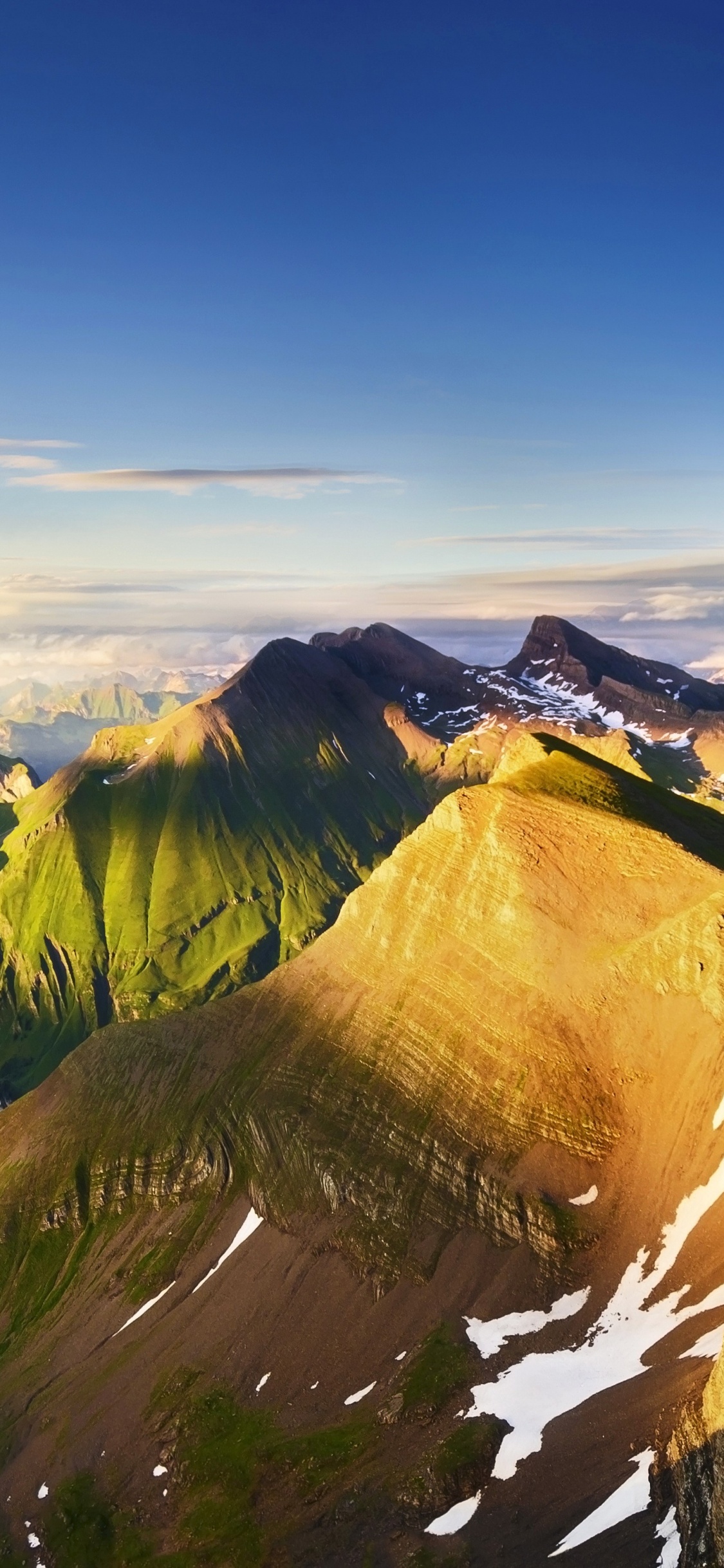 Brown and Green Mountains Under Blue Sky During Daytime. Wallpaper in 1125x2436 Resolution