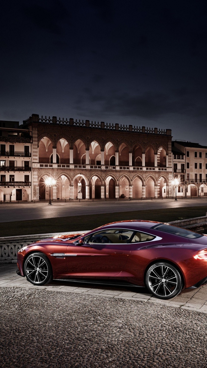 Coupe Rojo Estacionado en la Acera Durante la Noche. Wallpaper in 720x1280 Resolution