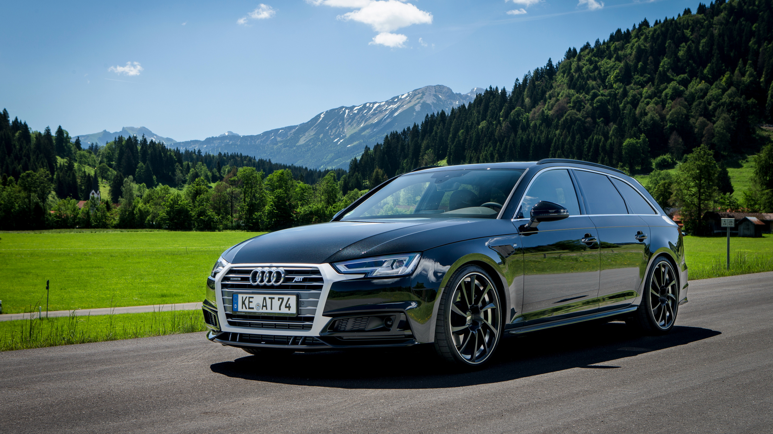 Black Audi Coupe on Road Near Green Grass Field and Green Mountains During Daytime. Wallpaper in 2560x1440 Resolution