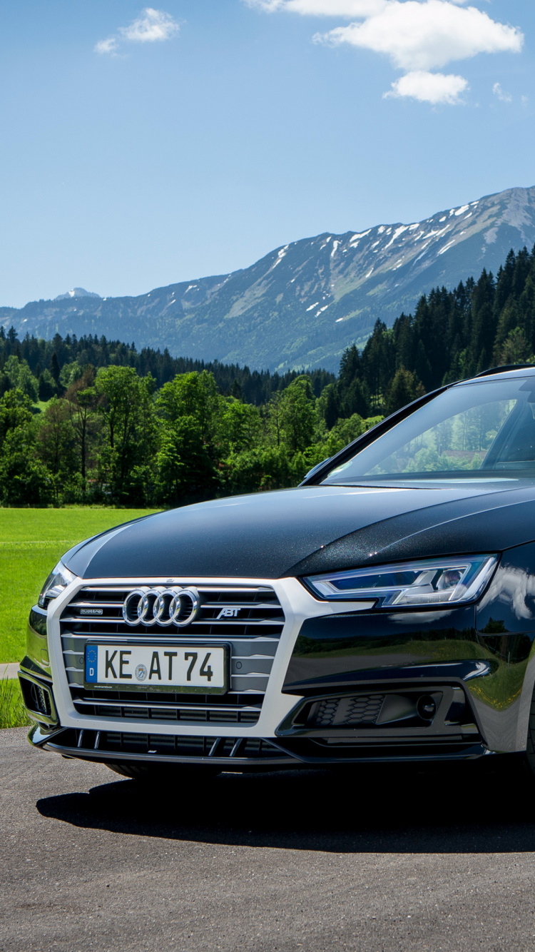 Schwarzes Audi Coupe Auf Der Straße in Der Nähe Von Grüner Wiese Und Grünen Bergen Tagsüber. Wallpaper in 750x1334 Resolution