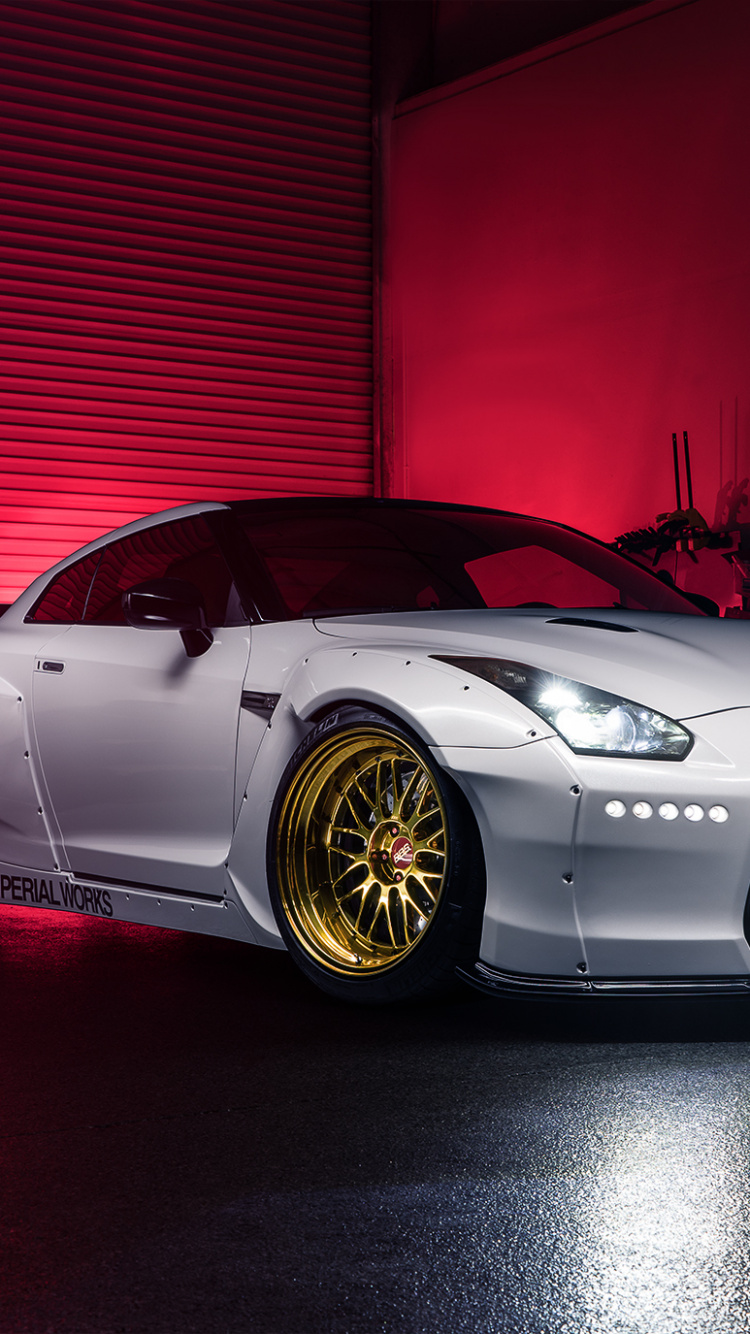 White Porsche 911 on Red Floor. Wallpaper in 750x1334 Resolution