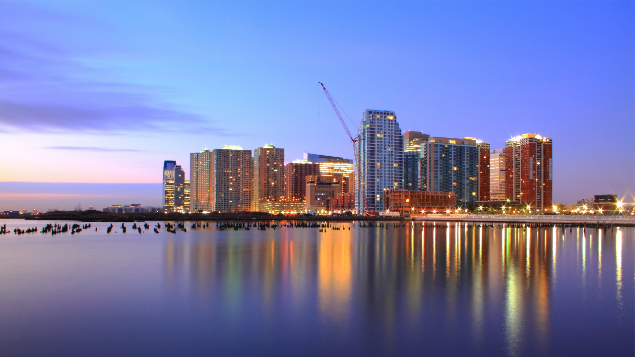 City Skyline Across Body of Water During Night Time. Wallpaper in 1280x720 Resolution