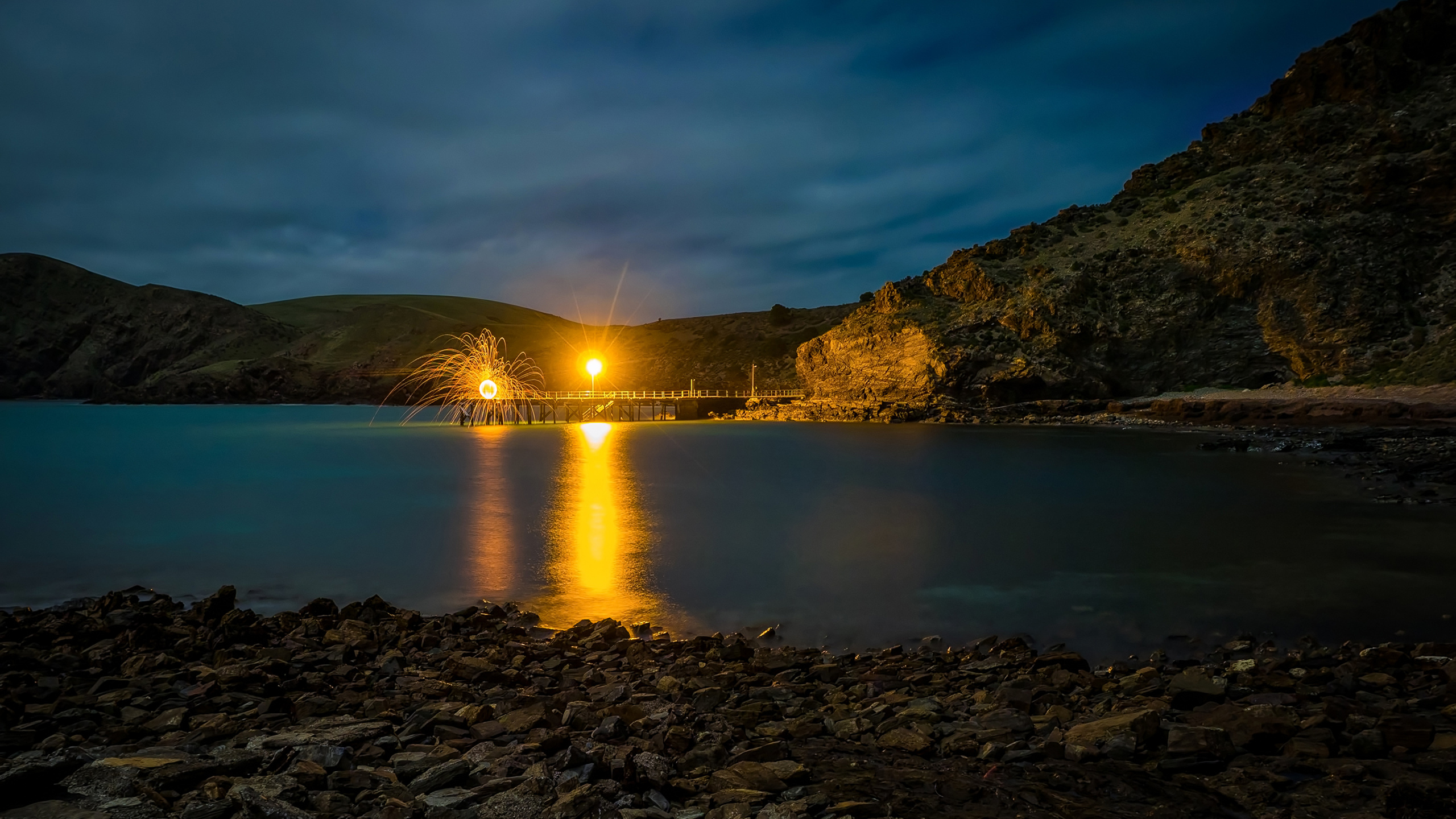 Body of Water Near Mountain During Night Time. Wallpaper in 2560x1440 Resolution