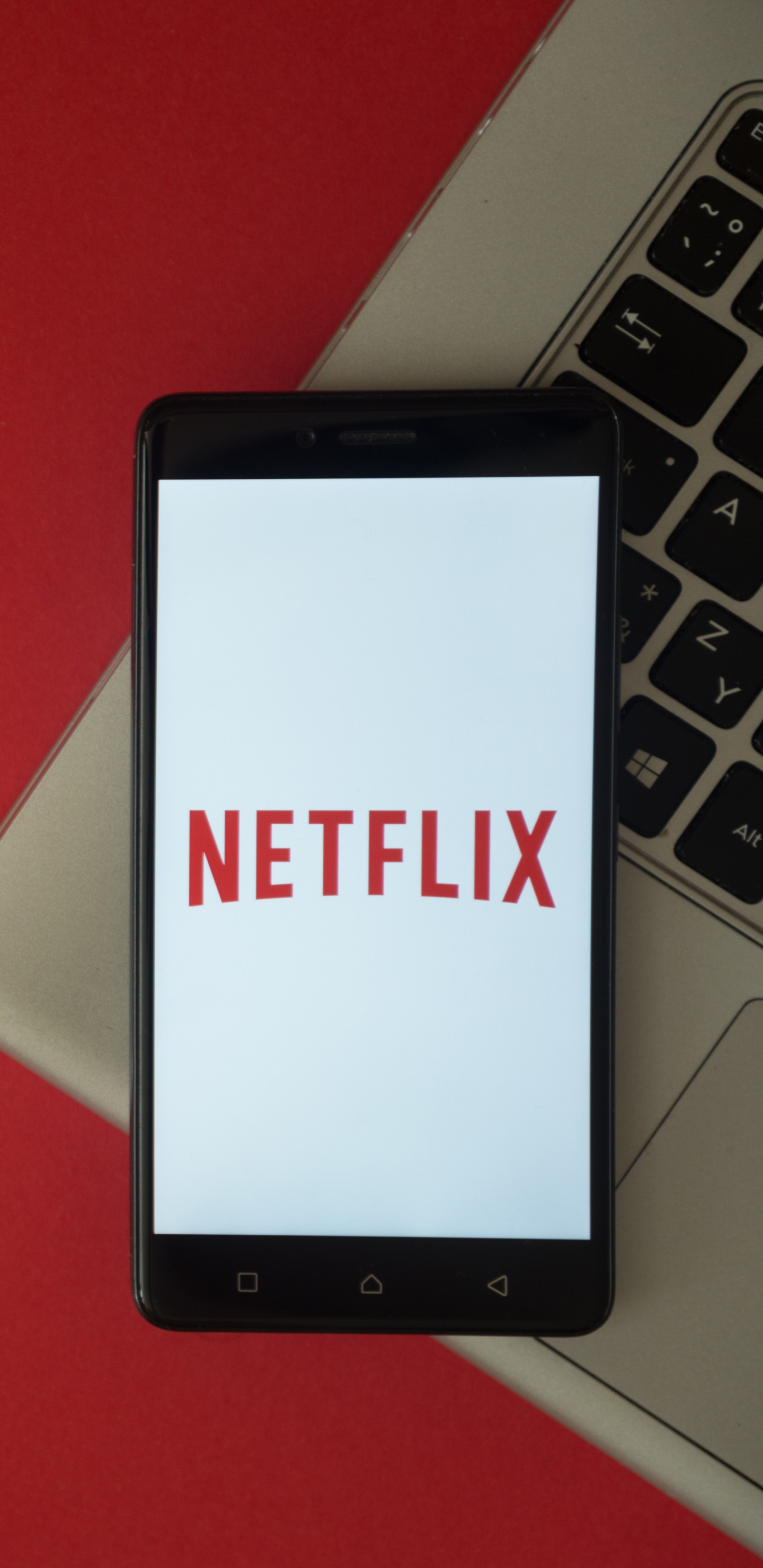 Black Tablet Computer on Red Table. Wallpaper in 1440x2960 Resolution