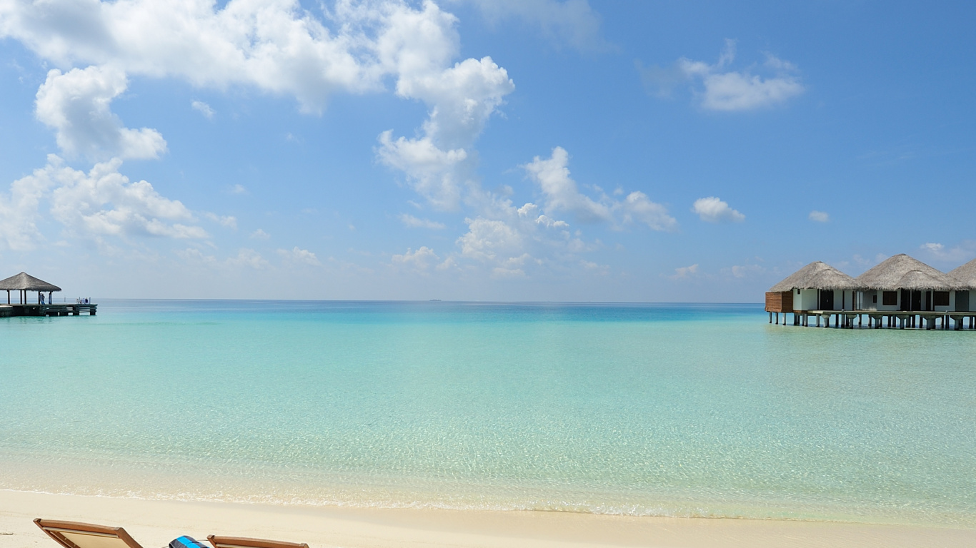 Brown Wooden Lounge Chairs on Beach During Daytime. Wallpaper in 1366x768 Resolution