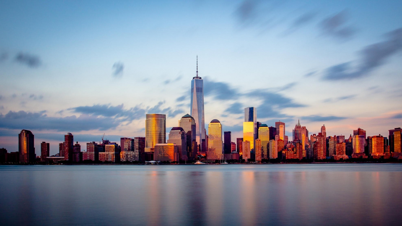 City Skyline Across Body of Water During Daytime. Wallpaper in 1366x768 Resolution