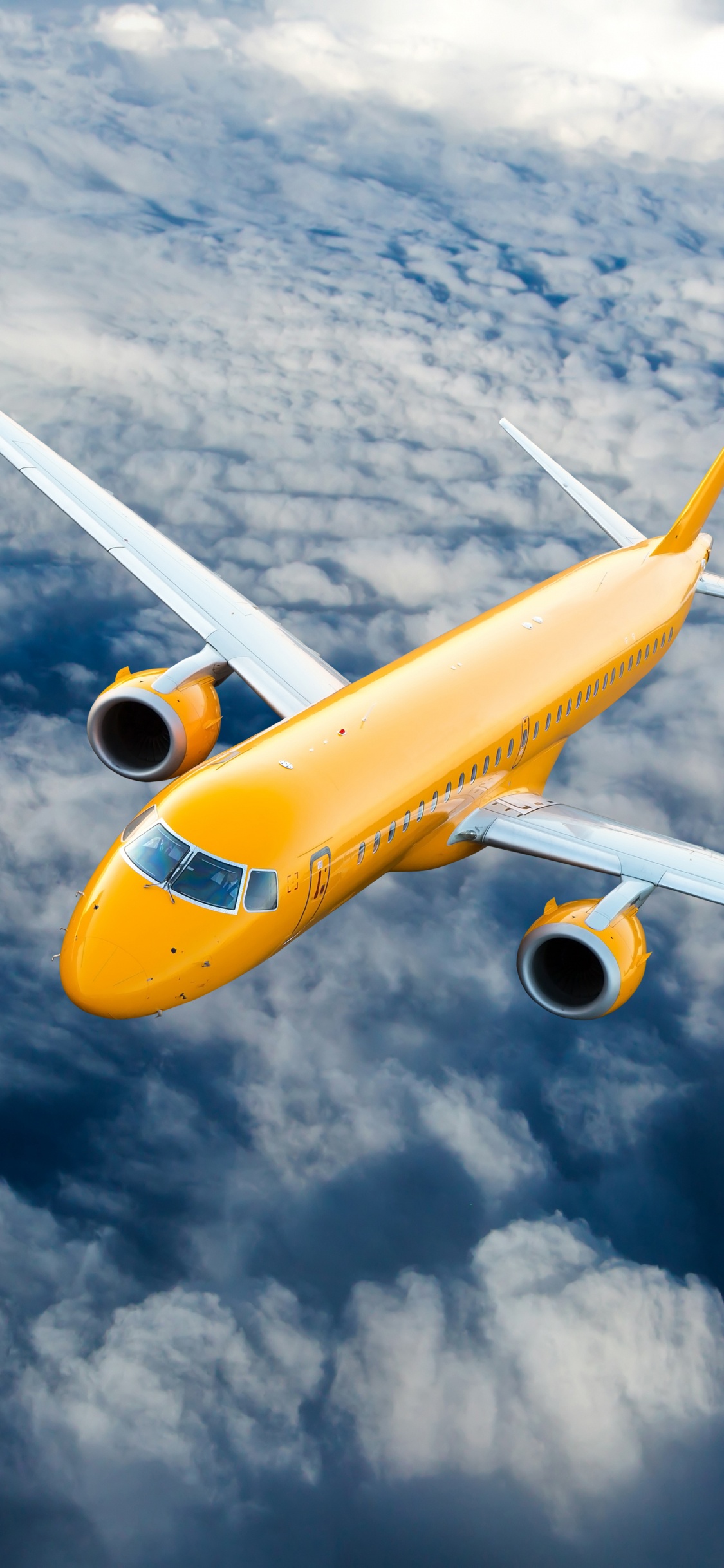 Gelbes Und Weißes Flugzeug, Das Tagsüber Unter Weißen Wolken Fliegt. Wallpaper in 1125x2436 Resolution