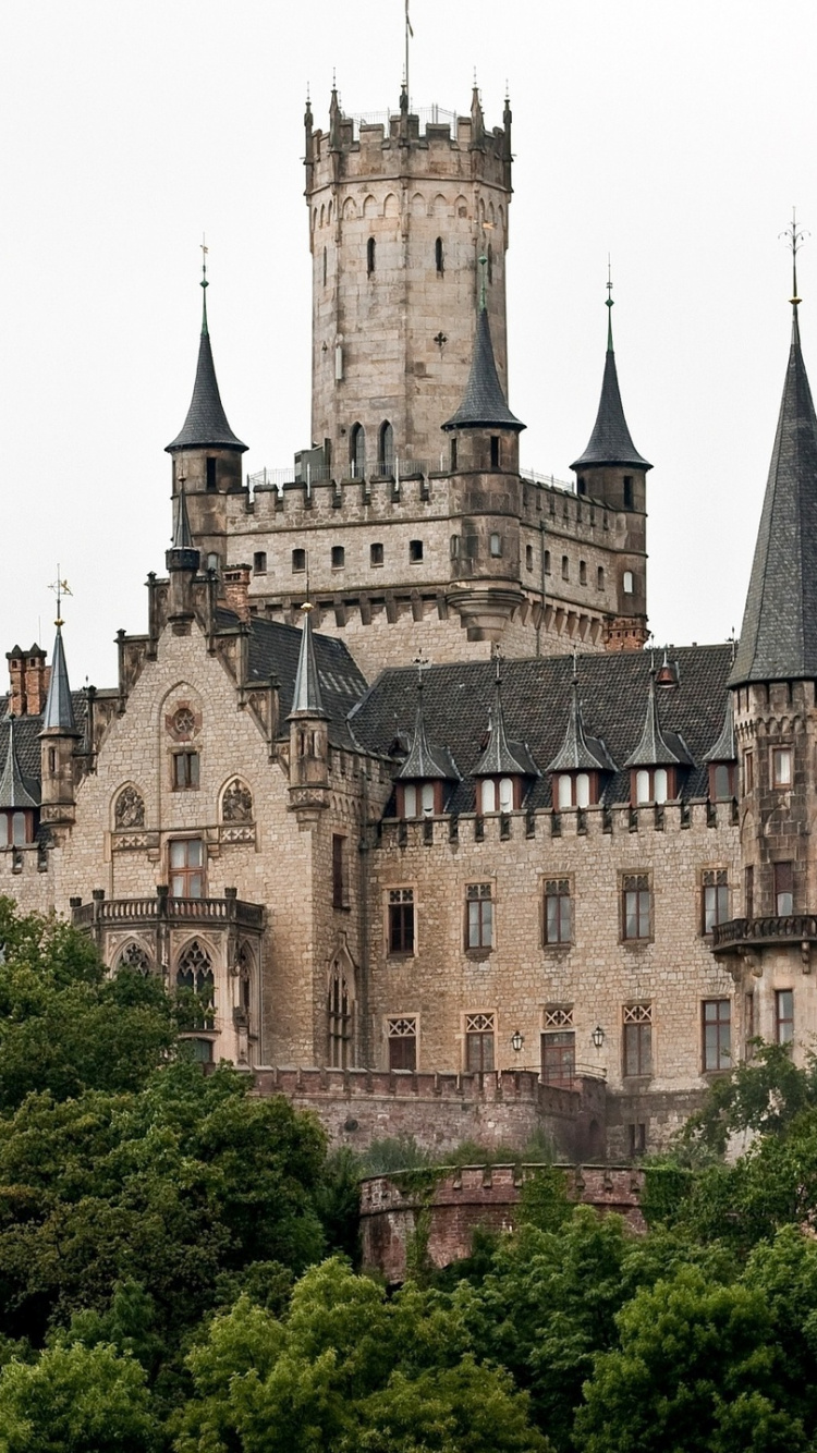 Brown and Gray Concrete Castle Surrounded by Green Trees During Daytime. Wallpaper in 750x1334 Resolution