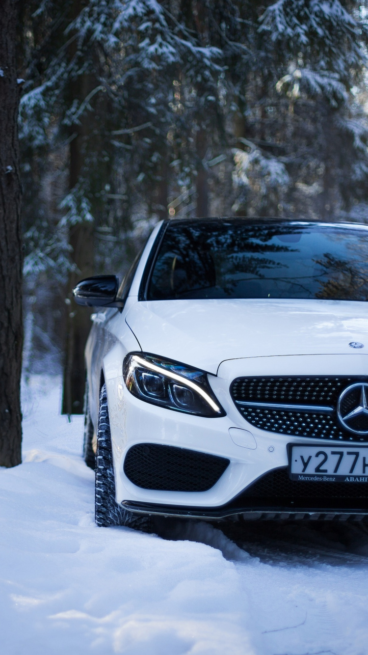White Mercedes Benz Car on Snow Covered Ground. Wallpaper in 750x1334 Resolution
