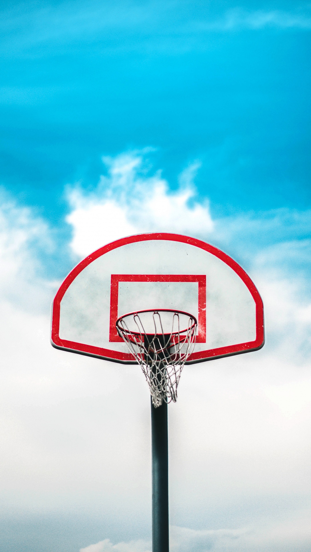 Basketball Hoop Under Blue Sky. Wallpaper in 1080x1920 Resolution
