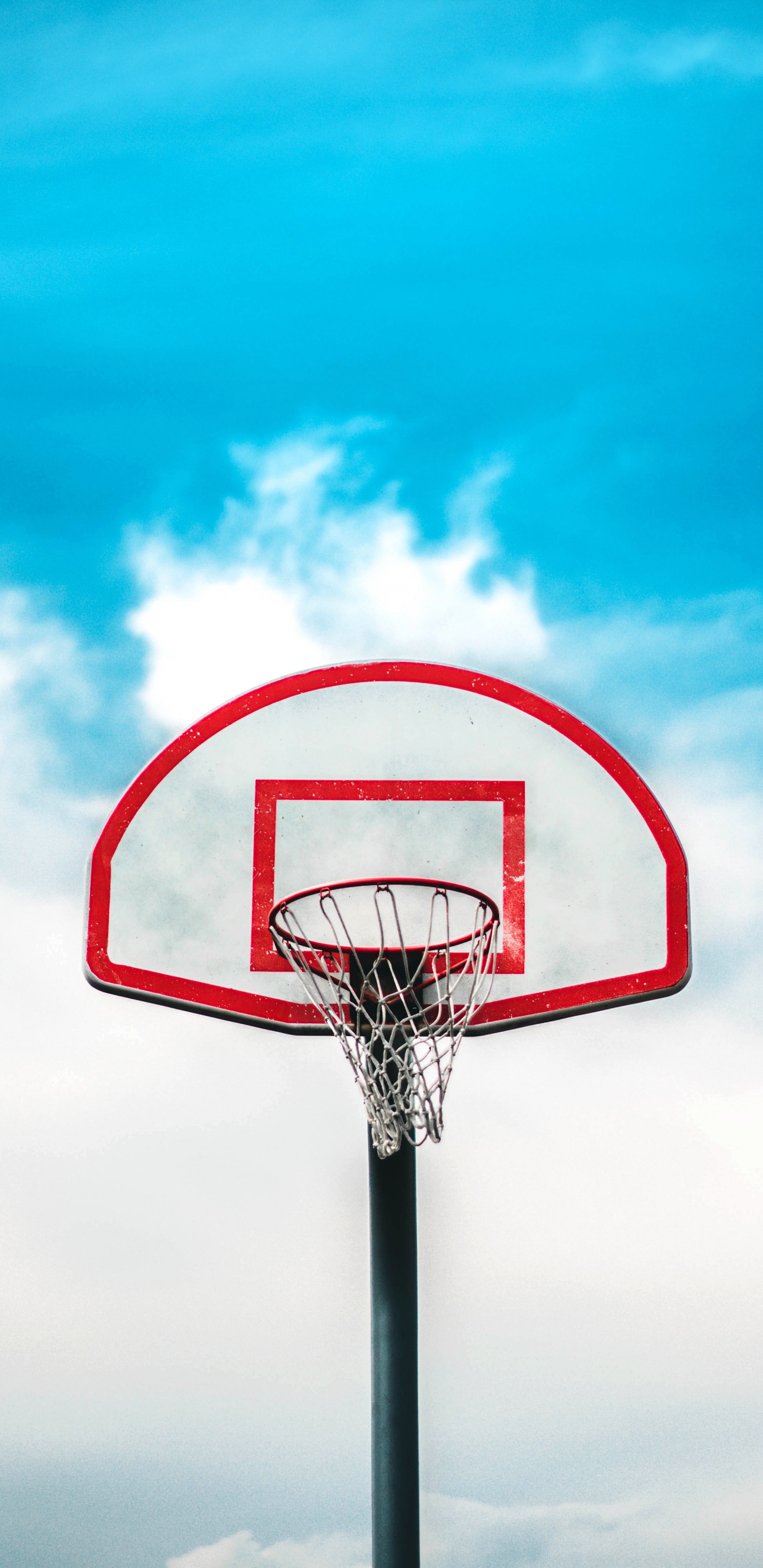 Basketball Hoop Under Blue Sky. Wallpaper in 1440x2960 Resolution
