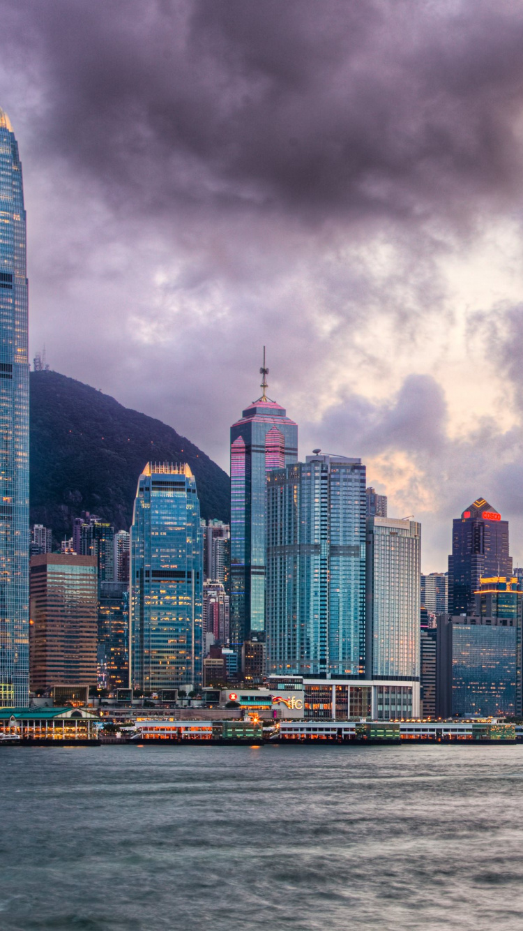 City Skyline Across Body of Water Under Cloudy Sky During Daytime. Wallpaper in 750x1334 Resolution