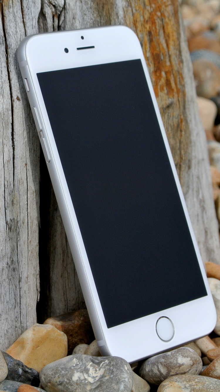 Silver Iphone 6 on Brown Wooden Table. Wallpaper in 750x1334 Resolution