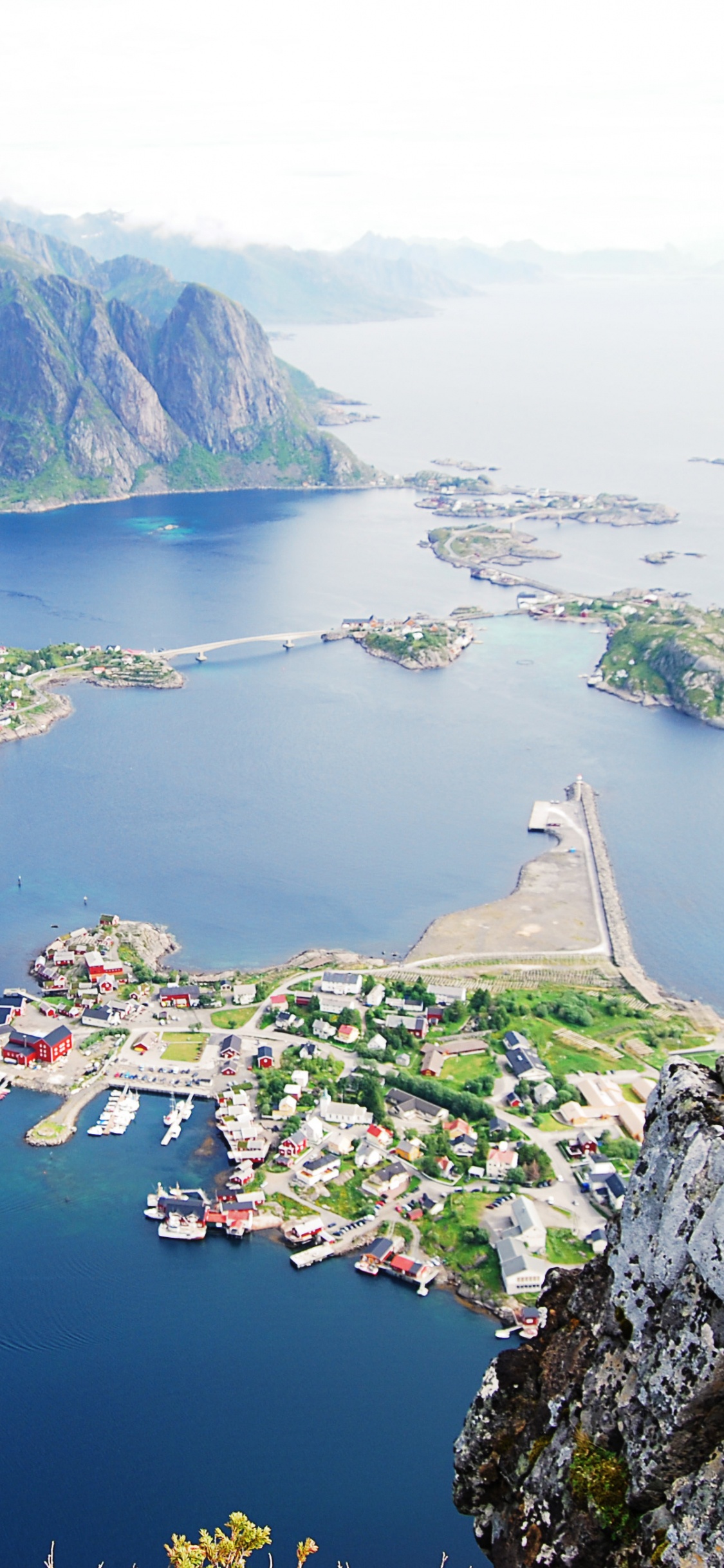 Aerial View of Green and Brown Mountains Beside Body of Water During Daytime. Wallpaper in 1125x2436 Resolution
