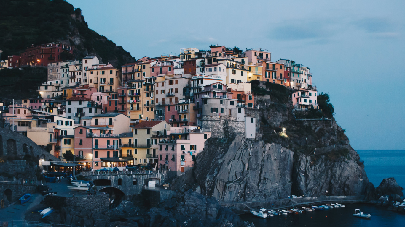 White and Brown Concrete Buildings on Mountain. Wallpaper in 1366x768 Resolution