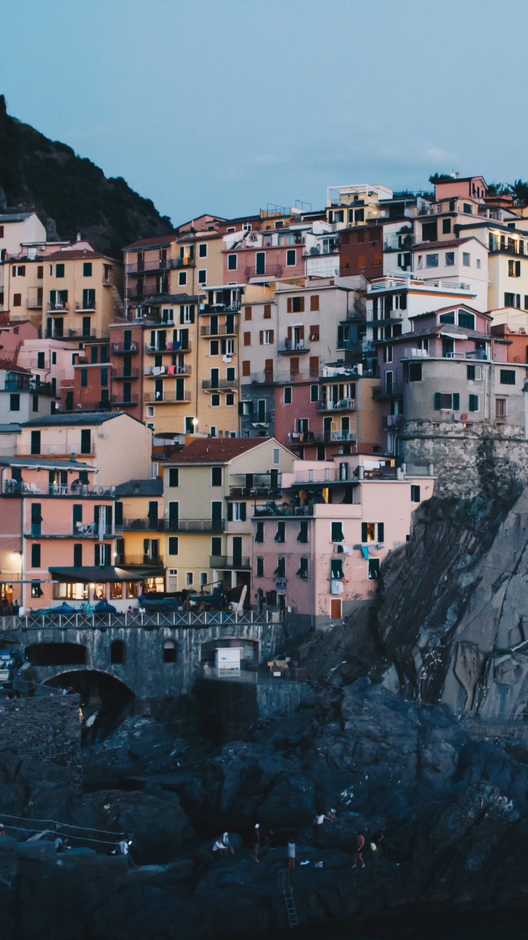 White and Brown Concrete Buildings on Mountain. Wallpaper in 750x1334 Resolution
