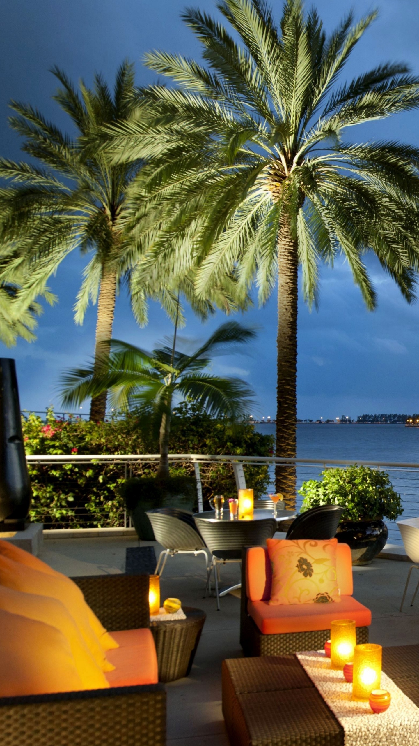 Brown and White Dining Table and Chairs Near Body of Water During Daytime. Wallpaper in 1440x2560 Resolution