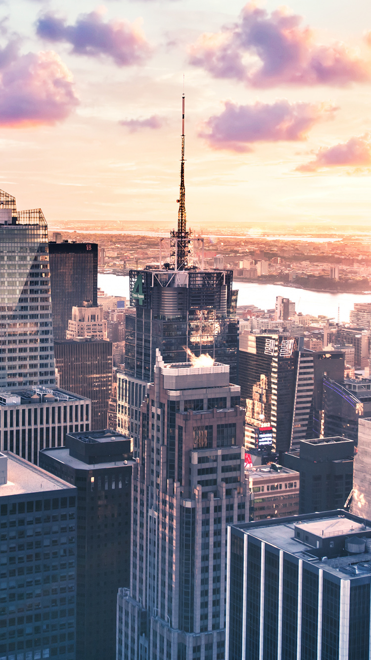 City Skyline Under Orange and Gray Cloudy Sky During Sunset. Wallpaper in 750x1334 Resolution