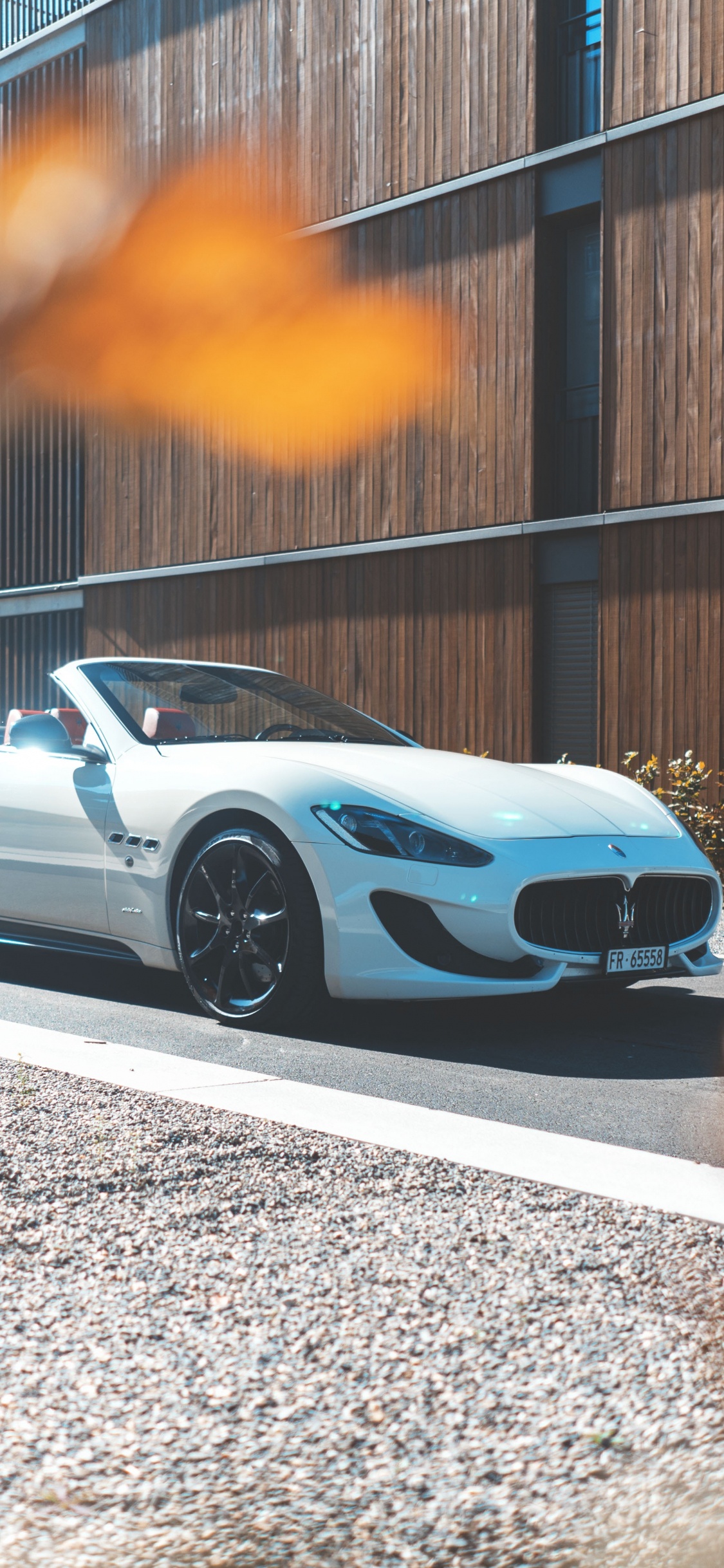 White Coupe Parked on Gray Concrete Road During Daytime. Wallpaper in 1125x2436 Resolution