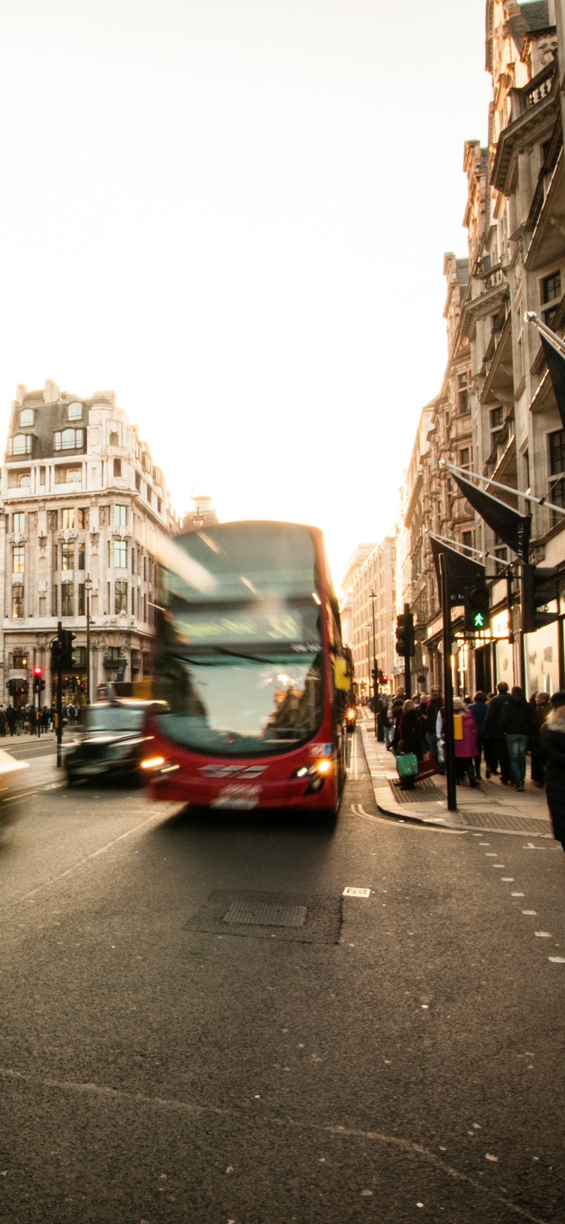 Cars on Road Between Buildings During Daytime. Wallpaper in 1125x2436 Resolution