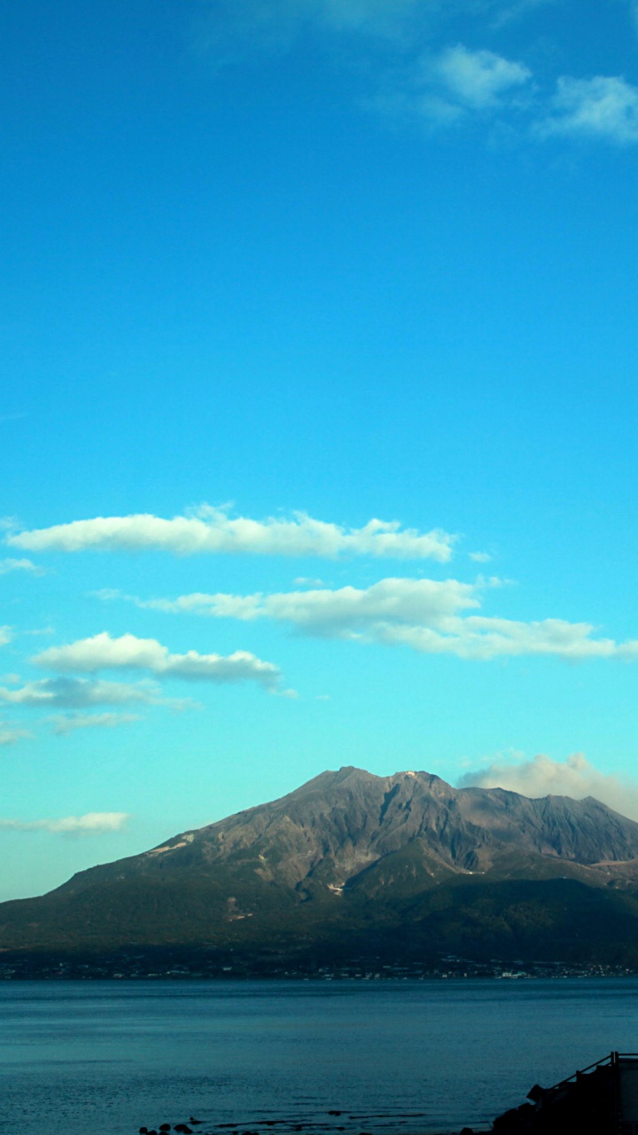 Green Mountain Near Body of Water Under Blue Sky During Daytime. Wallpaper in 720x1280 Resolution