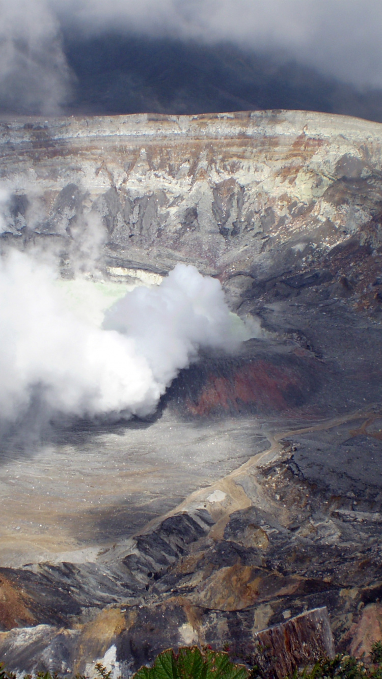 White Smoke Coming From Brown and Gray Mountain. Wallpaper in 750x1334 Resolution
