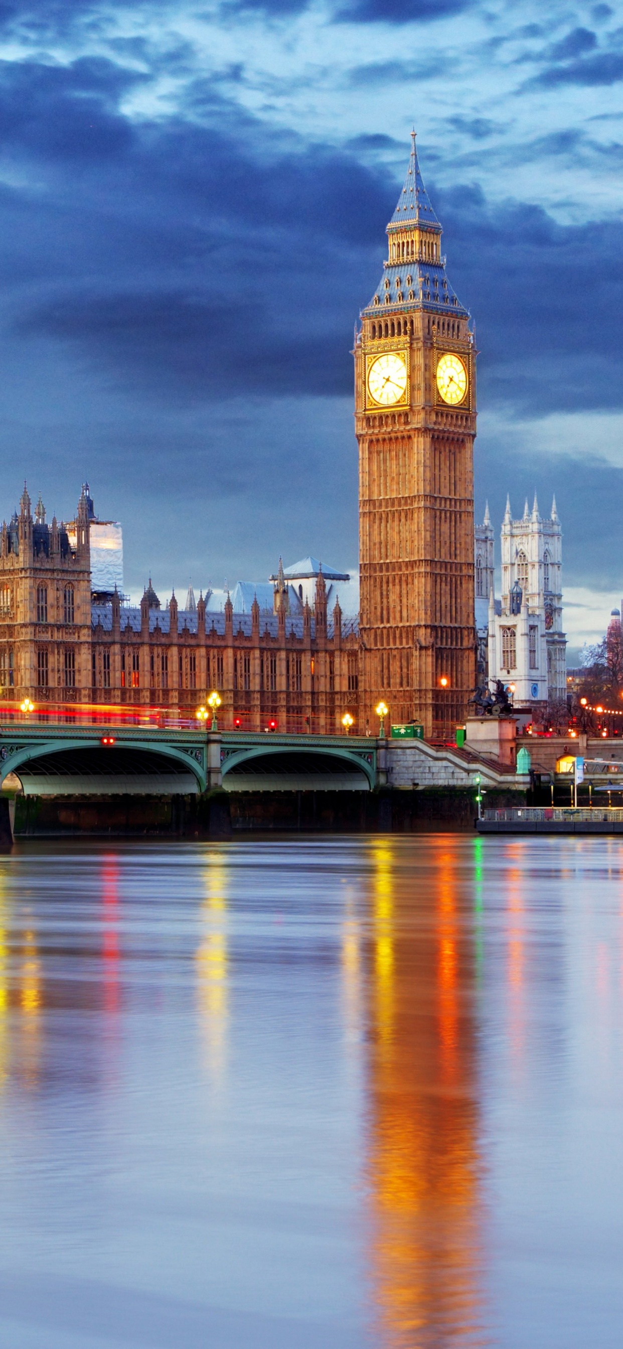 Brown Concrete Building Near Body of Water During Night Time. Wallpaper in 1242x2688 Resolution