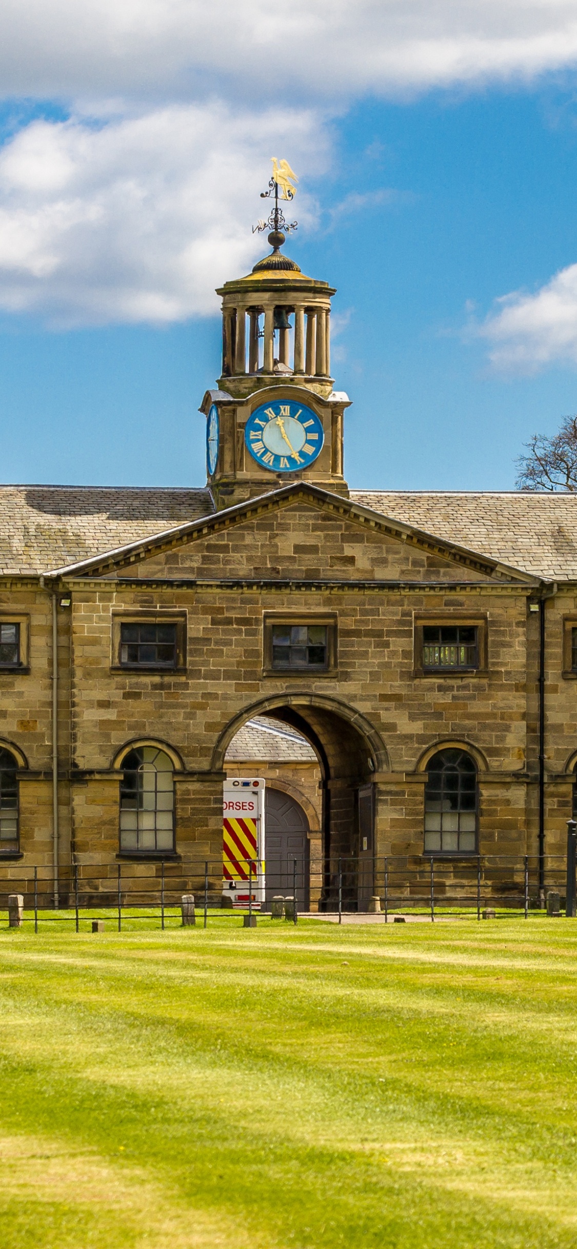 Brown Concrete Building Under Blue Sky During Daytime. Wallpaper in 1125x2436 Resolution